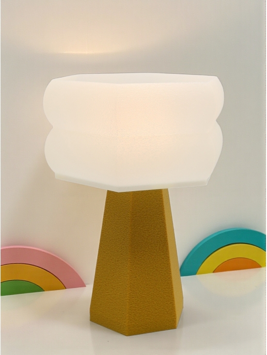 Lampe à poser Aline Pop Essentiel or moutarde allumée, abat-jour crème lumineux, ambiance rétro avec décor arcs-en-ciel pastel.